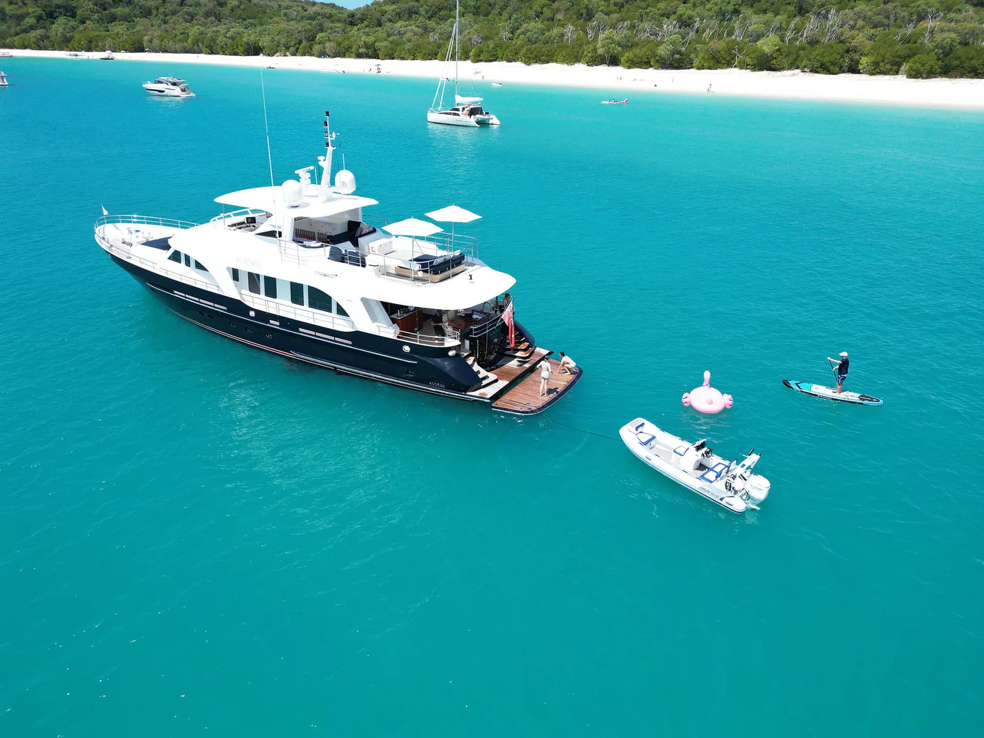 AURORA at anchor in turquoise water with tender and toys alongside