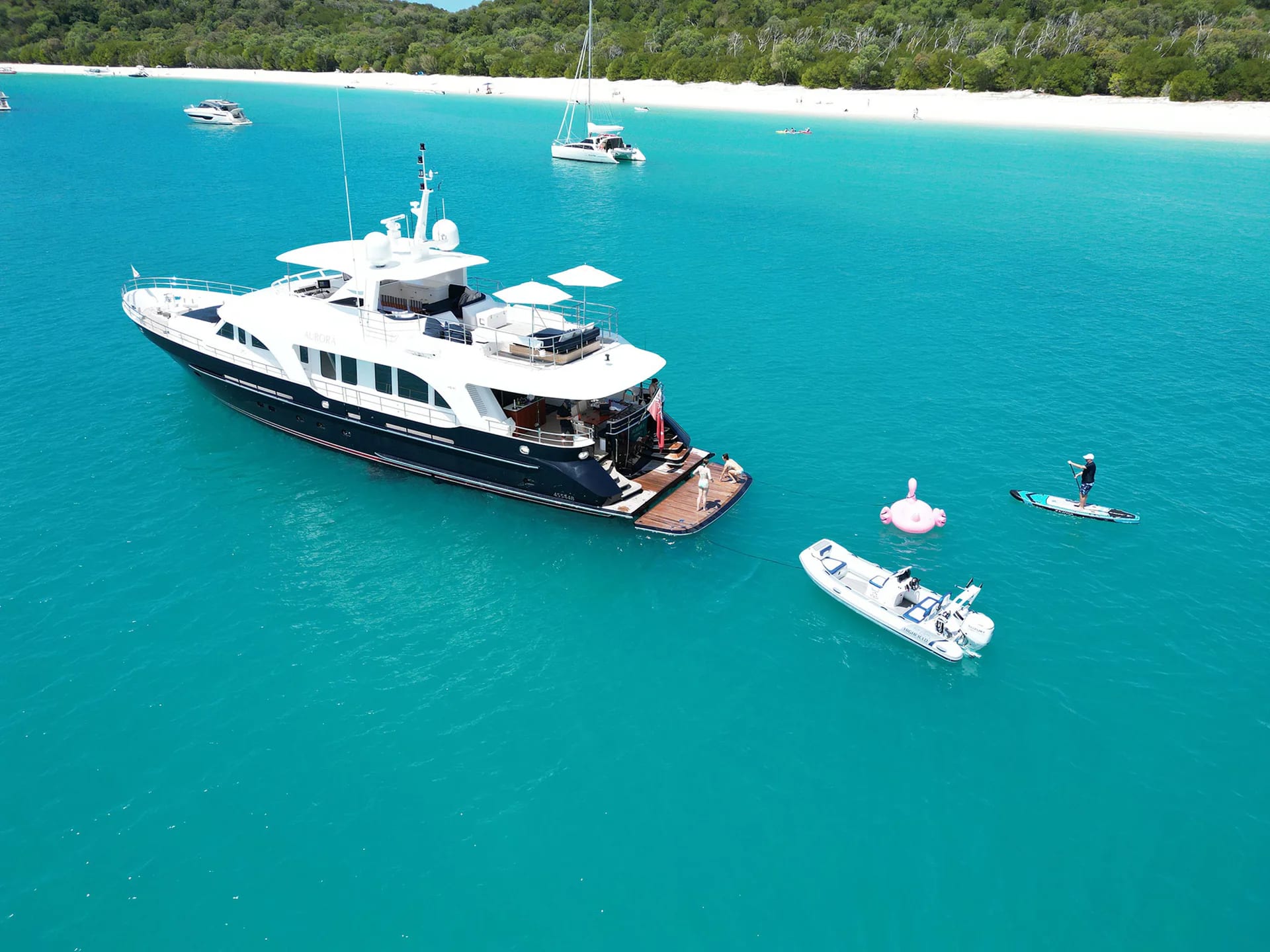 AURORA at anchor in turquoise water with tender and toys alongside