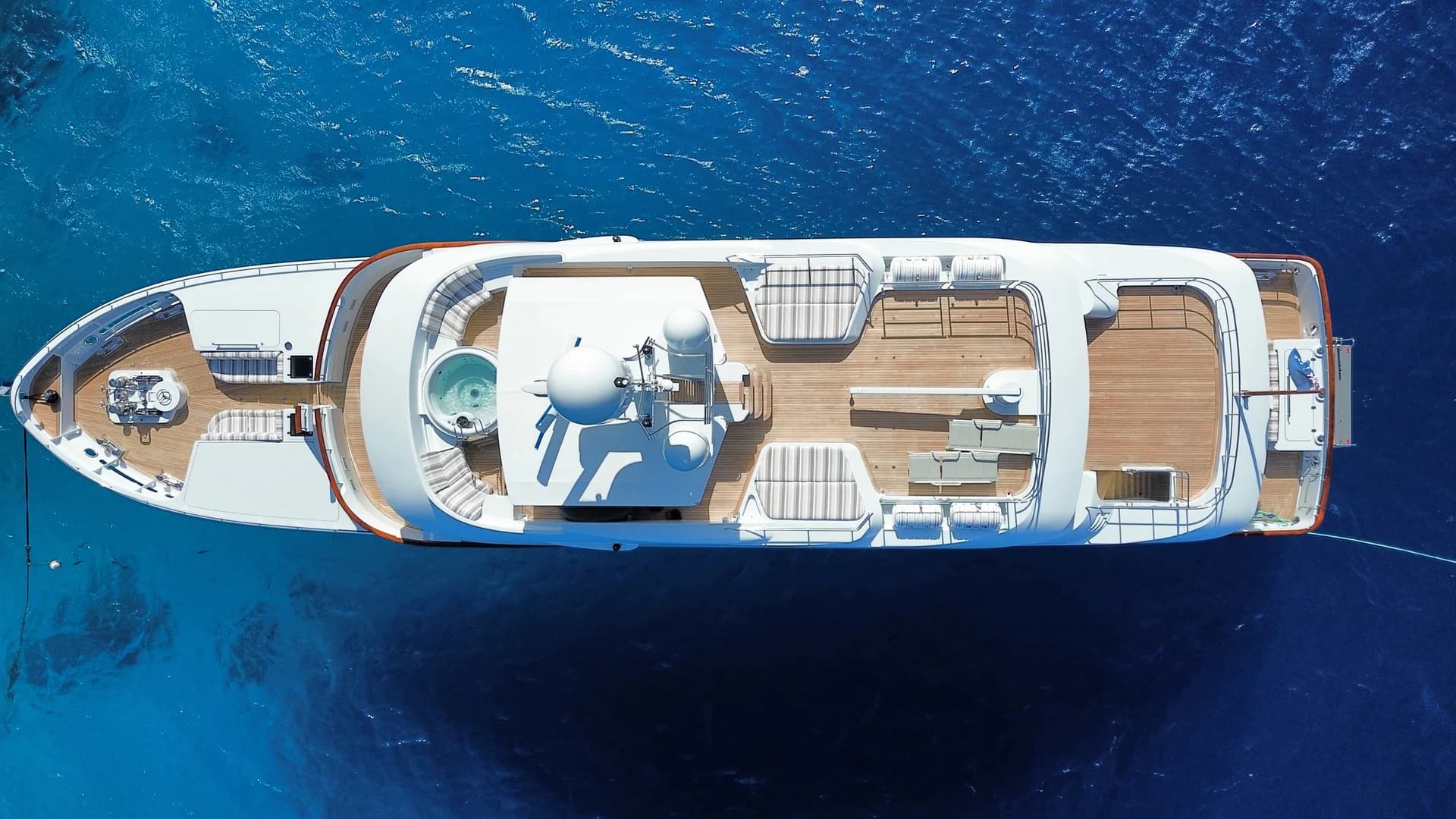 Top-down aerial view of BELUGA underway over deep blue water