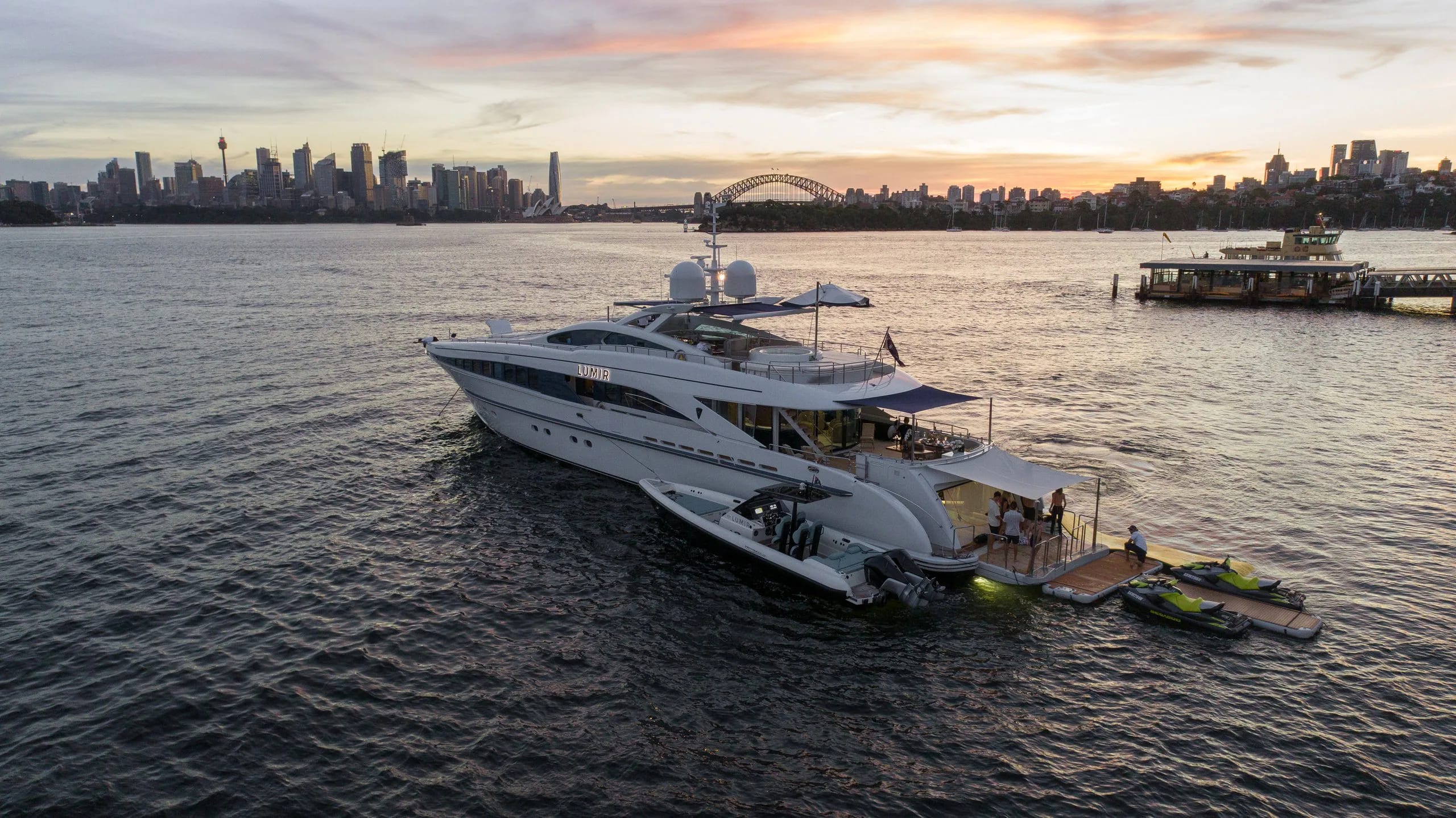 Lumir on Sydney Harbour with the city skyline at sunset