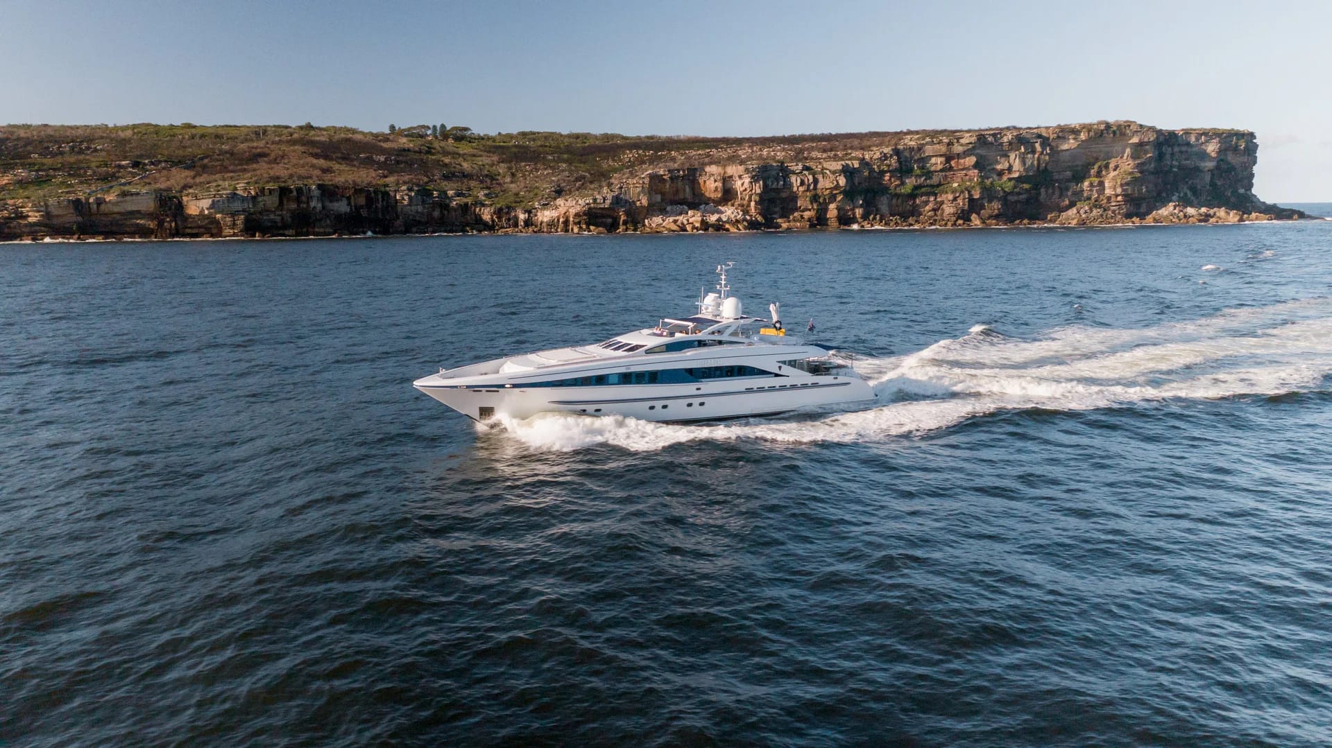 Lumir underway along a rocky coastline.