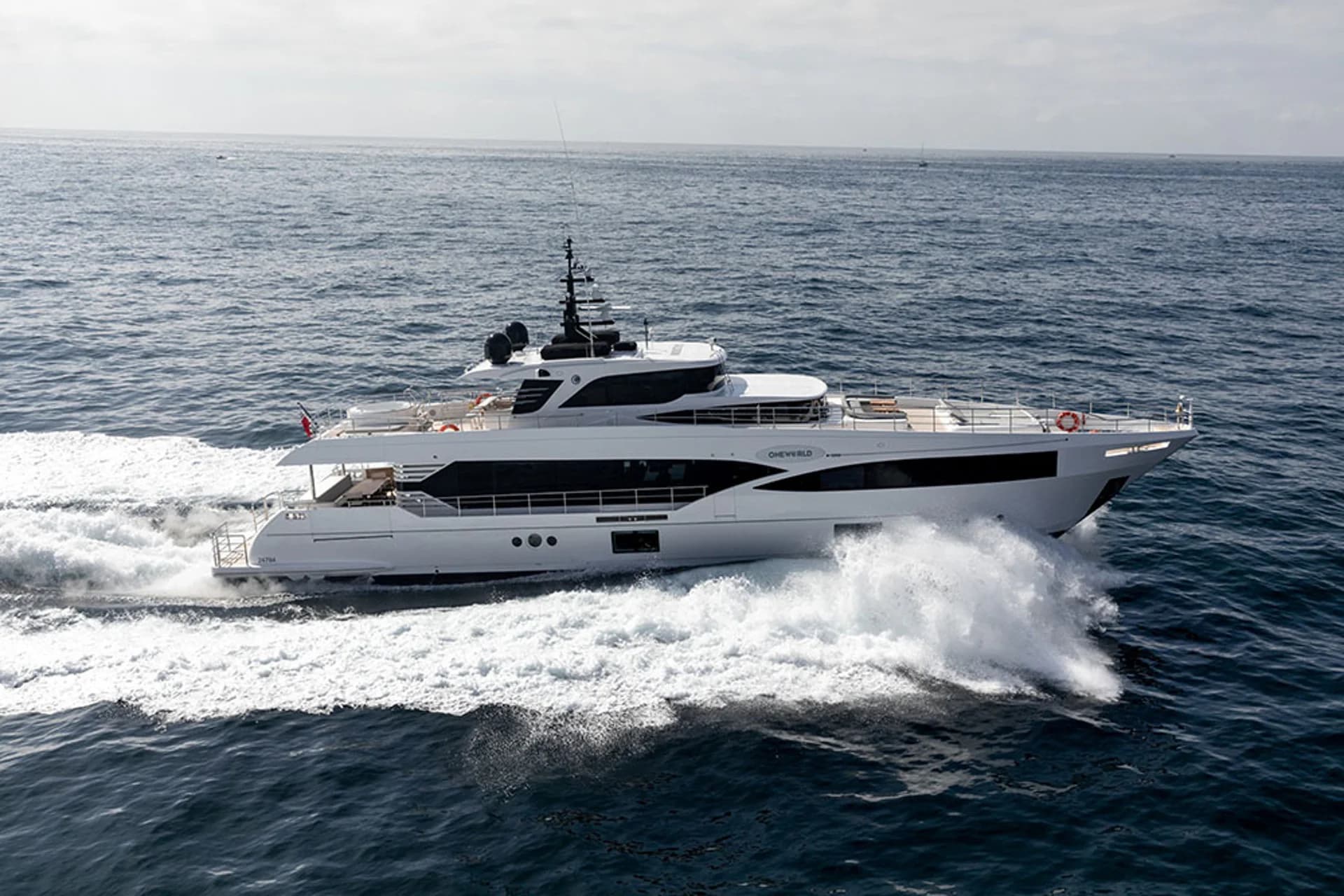 Oneworld underway in side profile on open water