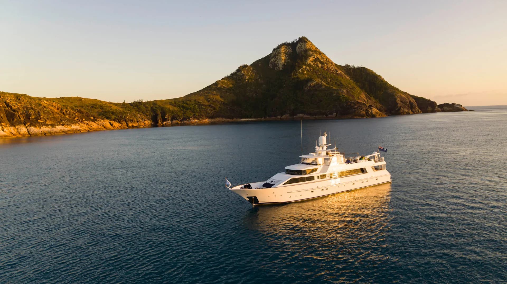 Phoenix One at golden hour seen from above with a mountain rising behind the bay