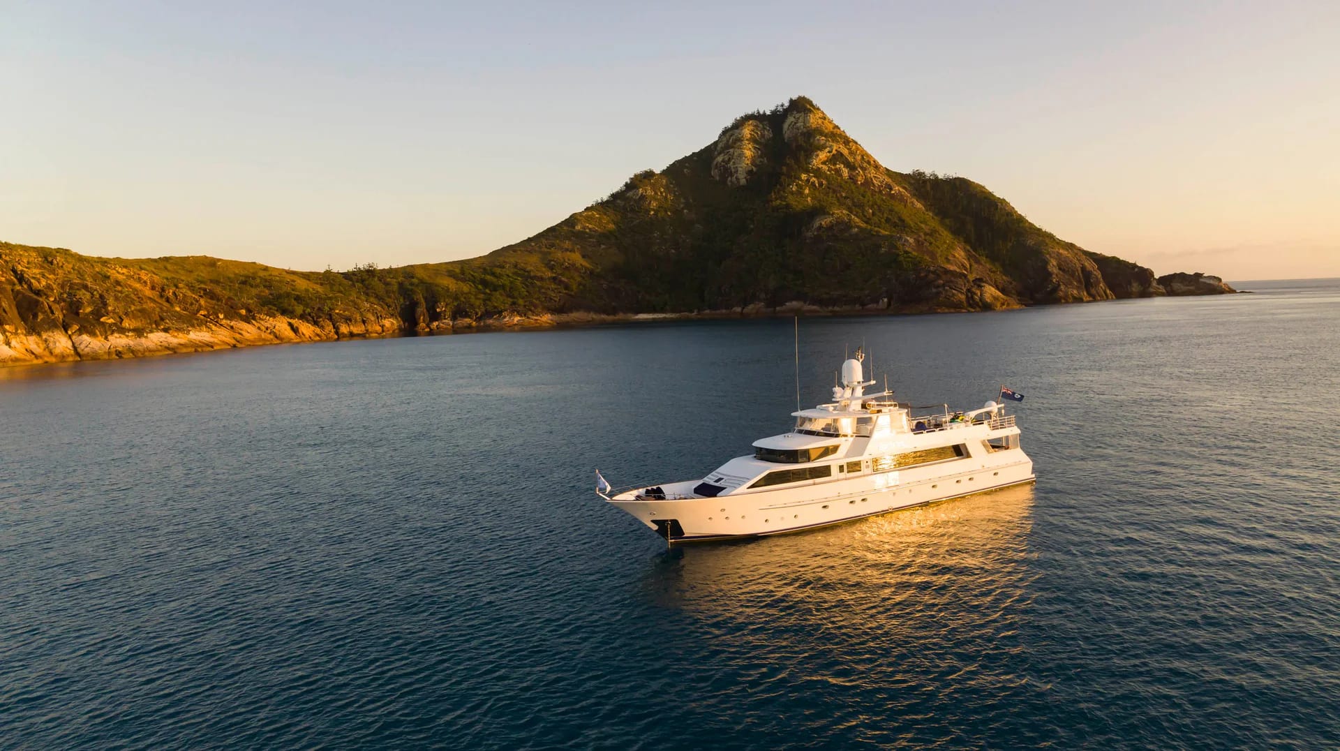 Phoenix One at golden hour seen from above with a mountain rising behind the bay
